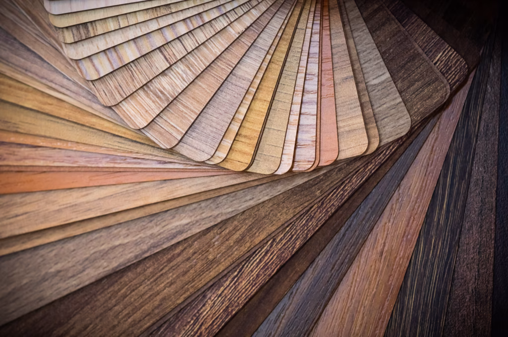 Various colors and grains of vinyl flooring are shown in a fan shape. No matter the room, you can always find an appropriate vinyl floor to match making it a wonderful rec room flooring option.